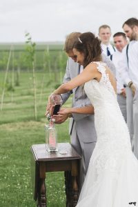 Bride and groom pour sand in their unity sand ceremony
