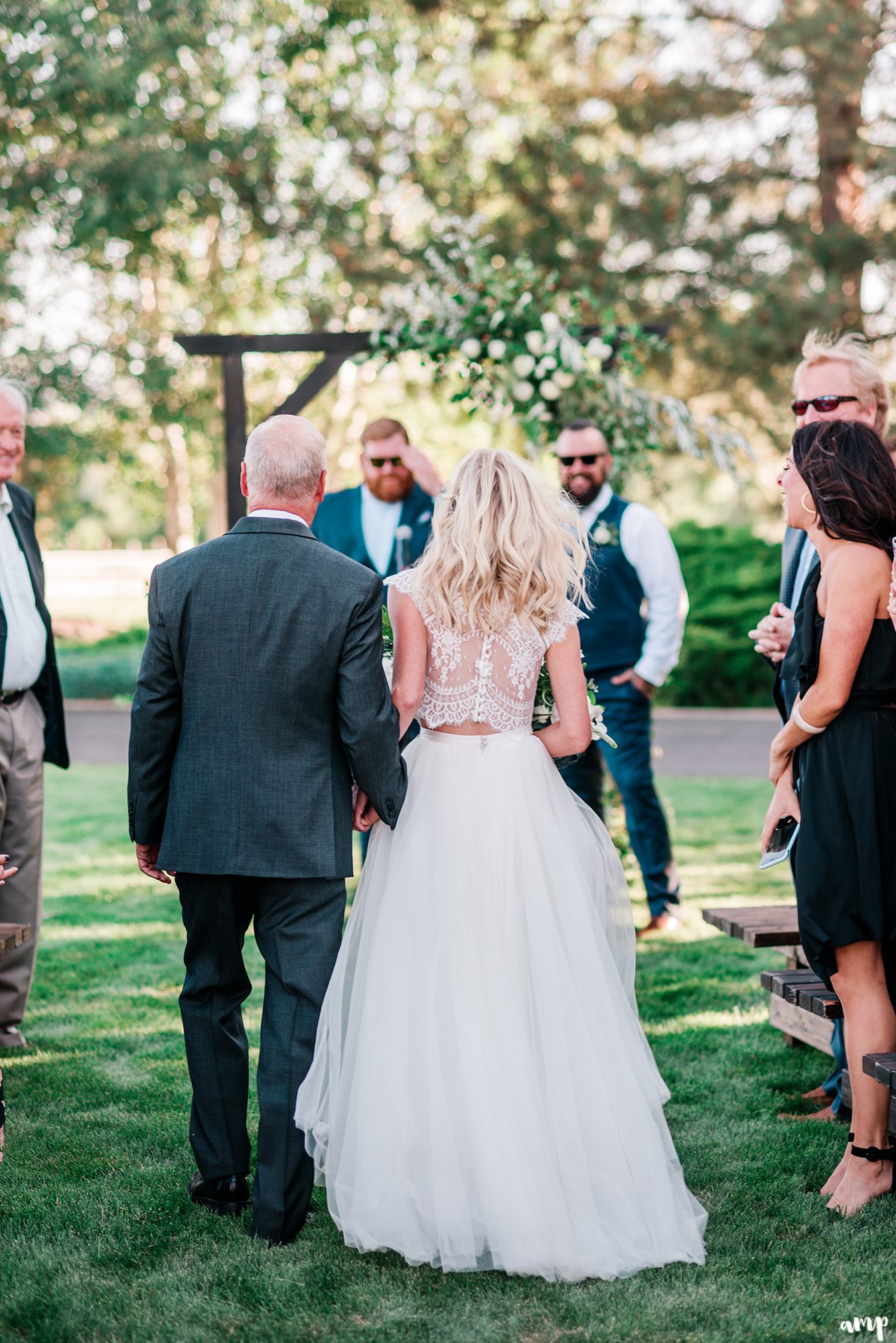 Shot of Beth and her dad walking down the aisle from behind | Grand Junction Backyard Wedding | amanda.matilda.photography